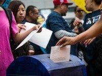 Activists calling for federal judges to reject challenges to President Obama's 'Deferred Action for Parents of Americans and Lawful Permanent Residents' (DAPA) program drop off letters stating their demands in a mock mail box outside the Jacob K. Javits Federal building, where naturalization ceremonies take place, on May 19, 2015 in New York City. DAPA, which has come under fire from conservatives, would create a system which would stop the deportation of certain immigrants who entered to U.S. illegally. (Photo by )