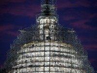 Workers stand on the scaffolding that surrounds the dome of the US Capitol which is undergoing restoration, November 17, 2015 in Washington, DC. The restoration of the cast iron dome is expected to take two years and cost as much as 60 million dollars (Photo by