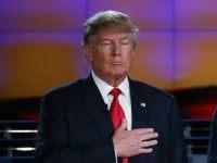 Republican presidential candidates Donald Trump (L) and U.S. Sen. Ted Cruz (R-TX) hold their hands over their hearts during the National Anthem during the CNN Republican presidential debate on December 15, 2015 in Las Vegas, Nevada. This is the last GOP debate of the year, with U.S. Sen. Ted Cruz (R-TX) gaining in the polls in Iowa and other early voting states and Donald Trump rising in national polls. (Photo by