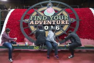 Rose Parade float decorators add finishing touches