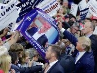 Republican presidential candidate Donald Trump signs autographs for supporters during a campaign stop at the Tsongas Center in Lowell, Mass., Monday, Jan. 4, 2016. (