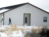 A member of the group occupying the Malheur National Wildlife Refuge headquarters, walks to one of its buldings Monday, Jan. 4, 2016, near Burns, Ore. The group calls itself Citizens for Constitutional Freedom and has sent a "demand for redress" to local, state and federal officials. Armed protesters took over the Malheur National Wildlife Refuge on Saturday after participating in a peaceful rally over the prison sentences of local ranchers Dwight and Steven Hammond.