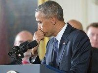 President Barack Obama pauses while speaking in the East Room of the White House in Washington, Tuesday, Jan. 5, 2016, about steps his administration is taking to reduce gun violence. Also on stage are stakeholders, and individuals whose lives have been impacted by the gun violence. )