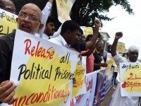 Sri Lankan activists demanding the release of Tamil detainees held in custody for long periods without trial demonstrate outside the main prison in Colombo on October 16, 2015.  The prisoners were arrested during Sri Lanka's 37-year civil war for suspected involvement with Tamil rebels fighting for a separate homeland for the ethnic minority, but remain in custody even after the end of the war in May 2009. AFP PHOTO / ISHARA S. KODIKARA        (Photo credit should read Ishara S. KODIKARA/AFP/Getty Images)