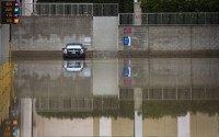 One of the remaining flooded cars from the Tuesday rains remains in one of the lower level parking lots at the Fashion Valley Mall, Wednesday morning. More rain is expected Wednesday, and throughout the week.