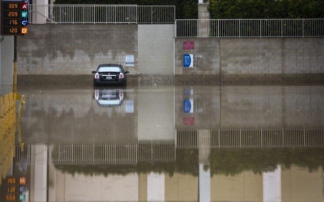 One of the remaining flooded cars from the Tuesday rains remains in one of the lower level parking lots at the Fashion Valley Mall, Wednesday morning. More rain is expected Wednesday, and throughout the week.