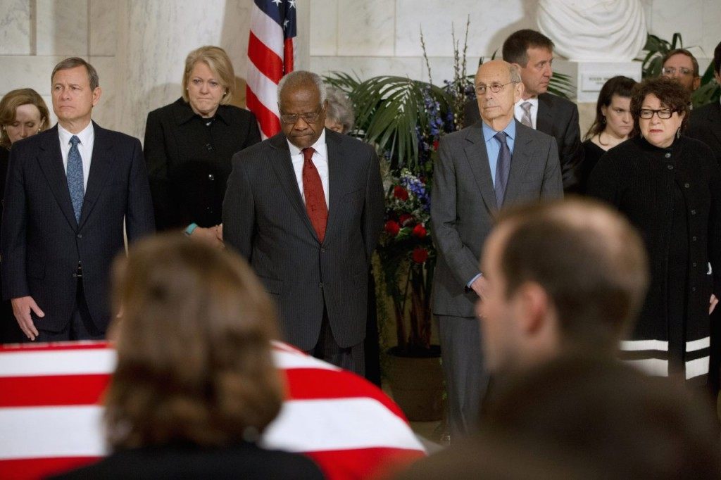 Chief Justice John Roberts, Jr., left, and from second from left, Ginny Thomas, next to her husband, Justice Clarence Thomas, Justice Stephen Breyer, and Justice Sonia Sotomayor, attend a private ceremony in the Great Hall of the Supreme Court in Washington, Friday, Feb. 19, 2016, where late Supreme Court Justice Antonin Scalia lies in repose. (AP Photo/Jacquelyn Martin, Pool)