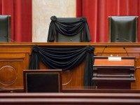 Supreme Court Justice Antonin Scalia’s courtroom chair is draped in black to mark his death as part of a tradition that dates to the 19th century, Tuesday, Feb. 16, 2016, at the Supreme Court in Washington. Scalia died Saturday at age 79. He joined the court in 1986 and was its longest-serving justice.