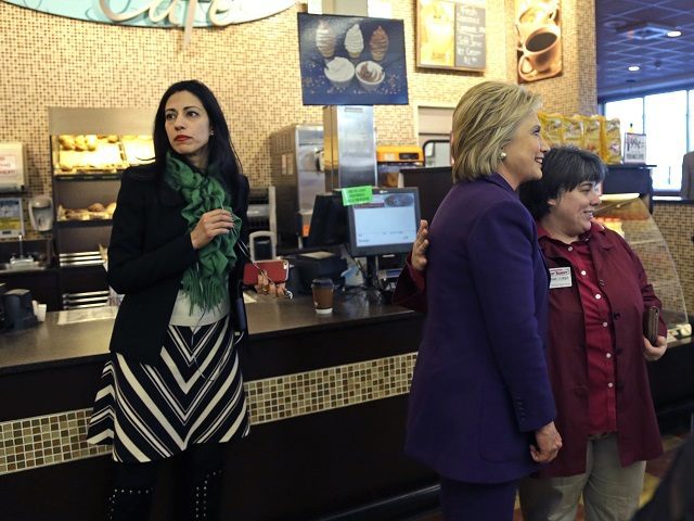 Huma Abedin, left, aide to Democratic presidential candidate Hillary Clinton, right, waits as she poses for a photo with an employee at Market Basket Supermarket, Tuesday, Feb. 2, 2016, in Manchester, N.H. (AP Photo/Elise Amendola)