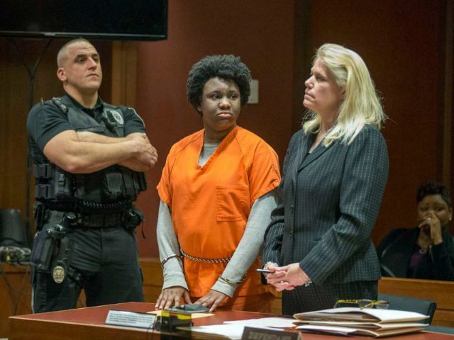 With her mother Juana Sully seated behind her, Hyphernkemberly Dorvilier, stands between a sheriff's deputy and her defense attorney Karen Thek as she listens to the charges against her. Dorvilier pleaded guilty Monday, Feb. 29, 2016, in Mount Holly, N.J., to aggravated manslaughter. She had previously pleaded not guilty to a murder charge. Authorities say the 23-year-old Pemberton Township resident doused her newborn with accelerant and set her on fire in January 2015. The baby had third-degree burns over 60 percent of her body. She died two hours after she was flown to a Philadelphia hospital. (Ed Hille/The Philadelphia Inquirer via AP)