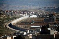 A section of Israel's separation barrier in east Jerusalem divides the Palestinian Shuafat refugee camp (right) from the Jewish settlement Pisgat Zeev