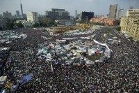 Egyptian anti-goverment demonstrators perform the Friday noon prayer during protests in Cairo's landmark Tahrir Square on February 11, 2011