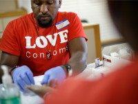 Reggie Batiste, left, program manager with AIDS Healthcare Foundation, administers a free HIV test as part of National HIV Testing Day, Thursday, June 27, 2013, in Atlanta. Health officials say more than 1.1 million people in the U.S. are living with HIV, but 20 percent of them don't know it. Health officials say HIV testing is critical to stopping the spread of the virus. Georgia ranks sixth in the nation for the number of AIDS cases reported through the end of 2009. (AP Photo/David Goldman)