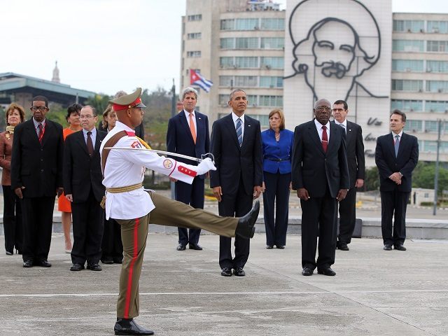 U.S. President Barack Obama, center, and Secretary of State John Kerry, center left, stand as an honor guard marches during a ceremony at the Jose Marti monument in Revolution Square in Havana, Cuba, Monday, March 21, 2016. Third from right is Salvador Valdes Mesa Vice-President of Cuba's State Council. "It is a great honor to pay tribute to Jose Marti, who gave his life for independence of his homeland. His passion for liberty, freedom, and self-determination lives on in the Cuban people today," Obama wrote in dark ink in the book after he laid a wreath and toured a memorial dedicated to the memory of Jose Marti. (AP Photo/Enric Marti)