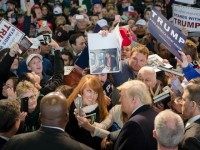 Republican presidential candidate Donald Trump, bottom center right, has his picture taken with attendees during a campaign stop at the Signature Flight Hangar at Port-Columbus International Airport, Tuesday, March 1, 2016, in Columbus, Ohio. (