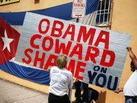 MIAMI, FL - JULY 20:  Protestes hang a sign that reads, 'Obama Coward Shame on You', as they show their displeasure, in the Little Havana neighborhood, with the normalization of the Cuban/United States relationship as the Cuban Embassy opens after a 54 year absence in Washington, DC on July 20, 2015 in Miami, Florida. The United States and Cuba have now established a restoration of full diplomatic relations 54 years after they had ended.  (Photo by Joe Raedle/Getty Images)