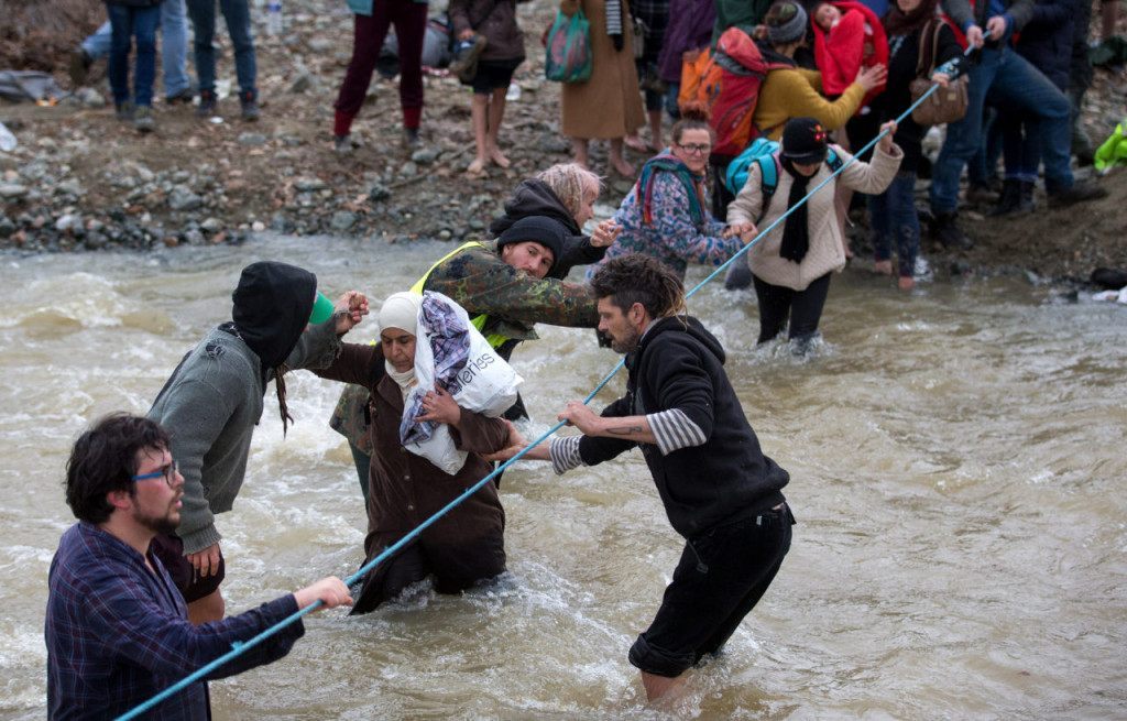 IDOMENI, GREECE - MARCH 14: Migrants try to cross a river after leaving the Idomeni refugee camp, on March 14, 2016 in Idomeni, Greece. The decision by Macedonia to close its border to migrants on Wednesday has left thousands of people stranded at the Greek transit camp. The closure, following the lead taken by neighbouring countries, has effectively sealed the so-called western Balkan route, the main migration route that has been used by hundreds of thousands of migrants to reach countries in western Europe such as Germany. Humanitarian workers have described the conditions at the camp as desperate, which has been made much worse by recent bouts of heavy rain. (Photo by Matt Cardy/Getty Images)