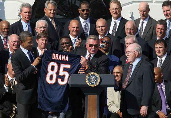 WASHINGTON, DC - OCTOBER 07: Former Chicago Bears head coach Mike Ditka (C) presents U.S. President Barack Obama (L), with a team jersey, while flanked by Defensive coordinator Buddy Ryan (R), and other members of the the 1985 Super Bowl Champion Chicago Bears, on the south lawn of the White House, on October 7, 2011 in Washington, DC. President Obama who is a Bears fan, realized the team never got to enjoy the customary ceremony given to the champions of the season, and invited the team to the White House.  (Photo by Mark Wilson/Getty Images)