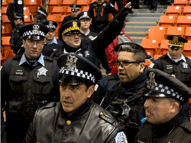 Chicagio police arrive as anti-Trump protesters take over during a Trump rally at the UIC Pavilion in Chicago on March 11, 2016. Republican White House hopeful Donald Trump cancelled his appearance at a Chicago rally Friday amid extraordinary scenes of chaos, with hundreds of protesters clashing with the frontrunner's supporters and police struggling to maintain order. / AFP / Tasos Katopodis 2016 (Photo credit should read