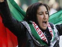 A woman waves a Palestinian flag as she takes part in a pro-Palestinian demonstration on October 10, 2015 in Paris, calling for a boycott of Israel and for the recognition of the State of Palestine.