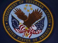 The emblem for the U.S. Department of Veteran's Affairs is seen as U.S. President Barack Obama speaks at Ft. Belvoir, Virginia, August 7, 2014. REUTERS/LARRY DOWNING