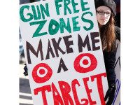 Emma Solorzano, 13, of Jefferson, holds a sign saying Gun Free Zones Make Me a Target at a rally protesting gun control legislation and supporting gun rights in Wiscasset on Saturday, March 9, 2013, About 175 people attended the rally, which was organized by Jessica Beckwith of Lewiston, who is forming the Maine Gun Rights Coalition. (Photo by Gregory Rec/Portland Press Herald via Getty Images)