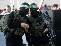 Palestinian militants of the Ezzedine al-Qassam Brigades, the armed wing of the Hamas movement, talk as they take part in an anti-Israel rally on February 26, 2016, in the southern Gaza Strip town of Rafah.