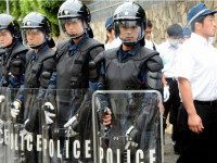 KOBE, JAPAN - JUNE 03: (CHINA OUT, SOUTH KOREA OUT) Riot police stand guard while police officers enter the Japan's biggest Yakuza syndicate 'Yamaguchi Gumi' headquarters for a raid on June 3, 2015 in Kobe, Hyogo, Japan. Police have arrested a member of the gang group on suspicion of fraud, opened a stall with false apprications and the sales had flown to the syndicate. (Photo by The Asahi Shimbun via Getty Images)