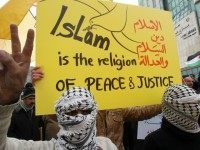 Supporters and members of the Palestinian Fatah movement gesture during a rally in support of Islam in the West Bank town of Hebron on January 15,2015,and against the new cover of Charlie Hebdo, published in Paris, that again featured the Prophet Mohammed on its cover.