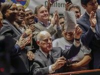 California Gov. Jerry Brown lifts a signed bill creating highest statewide minimum wage at $15 an hour by 2022 at the Ronald Reagan building in Los Angeles, Monday, April 4, 2016. California and New York acted Monday to gradually push their statewide minimum wages to $15 an hour, the highest level in the nation(AP Photo/Nick Ut)