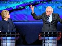 Democratic U.S. presidential candidate Hillary Clinton (L) listens to rival Bernie Sanders during the Democratic U.S. presidential candidates' debate in Flint, Michigan, March 6, 2016. REUTERS/Jim Young  TPX IMAGES OF THE DAY - RTS9KWH