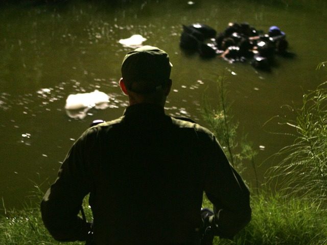 A US Border Patrol agent watches as a group of people use inner tubes to float down the New River, reportedly the most polluted river in the US, after illegally crossing the US/Mexico border on March 27, 2005 near Calexico, California. The black plastic bags are for carrying a dry change of clothing so as to blend in with locals in the city, trying to avoid detection by US Border Patrol agents. Border Patrol agents avoid contact with the contaminated water because of its toxic chemicals, raw sewage, and 43 diseases reported to be in it, but prefer to nab floating immigrants after they come ashore. In 1995, the launch of the North American Free Trade Agreement (NAFTA) brought a two-way trade boom between the US and Mexico. The Bush administration has set forth efforts to tighten security to prevent terrorists or their weapons from crossing the border, an effort that could slow the wheels of commerce. (Photo by