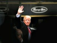 FILE - In this April 9, 2016 file photo, Republican presidential candidate Donald Trump acknowledges supporters while leaving Trump Tower in New York. Trump, Hillary Clinton and Bernie Sanders are all boasting about their New York City credentials. (AP Photo/Julio Cortez, File)
