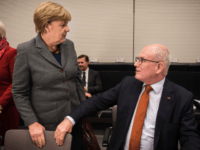 Leader of CDU/CSU parliamentary group Volker Kauder speaks with German Chancellor Angela Merkel at a conservative CDU/CSU parliamentary group meeting at the German lower house of parliament (Bundestag) on November 26, 2015 in Berlin.