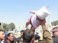 WATCH: The Moment A Migrant Threatens to Throw A Newborn Baby at Greek Harbour Officers