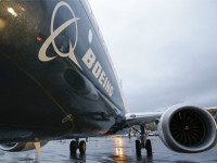 Boeing's first 737 MAX, named the 'Spirit of Renton,' sits on the tarmac Dec. 8 at the Boeing factory in Renton, Washington. Boeing aircraft orders fell by nearly half in 2015 even as deliveries rose to a record, the aerospace giant said Thursday. Boeing said that net orders for new aircraft dropped to 768 last year from 1,432 in 2014, putting it behind rival Airbus, which is expected to report well over 1,000 orders for last year. | AFP-JIJI