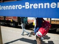 Alex (L), a 28-year-old from Ethiopia and 19-year-old Abel (C) walk on a plattform towards a train to Innsbruck, Austria, at the Brenner Pass at the Austrian border on 21 July, 2015, in Bolzano, Italy.