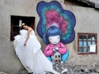 A China bride poses for wedding photos at Kangding Road where old houses are demolished on January 22, 2015 in Shanghai, China.