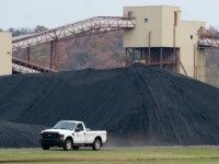pickup truck drives past a pile of coal at American Electric Power's (AEP) Mountaineer coal power plant in New Haven, West Virginia, October 30, 2009. In cooperation with AEP, the French company Alstom unveiled the world's largest carbon capture facility at a coal plant, so called 'clean coal,' which will store around 100,000 metric tonnes of carbon dioxide a year 2.1 kilometers (7,200 feet) underground.