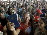 A Cuban migrant man receives his passport with the visa granted by the immigration office at the border post with Panama in Paso Canoas, Costa Rica November 14, 2015. REUTERS/JUAN CARLOS ULATE left1 of 3right left2 of 3right left3 of 3right left1 of 3right