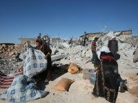 Palestinians recover belongings from the rubble of their family house after it was destroyed by Israeli army tractors early on November 25, 2010 in the West Bank village of Yatta near Hebron.