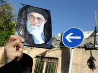 An Iranian woman holds a portrait of Iran's supreme leader Ayatollah Ali Khamenei duringa demonstration against the Saudi-led coalitions Operation Decisive Storm against the Huthi rebels in Yemen, outside the Saudi embassy in Tehran on April 13, 2015.