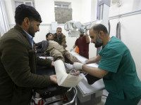 An Afghan man receives treatment at a hospital after a suicide car bomb attack in Kabul, Afghanistan April 19, 2016. REUTERS