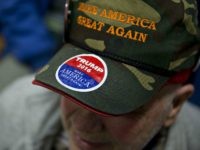 Attendee Rich Travers wears a 'Make America Great Again' hat before Donald Trump, president and chief executive of Trump Organization Inc. and 2016 Republican presidential candidate, not pictured, speaks during a campaign rally at Pennichuck Middle School in Nashua, New Hampshire, U.S., on Monday, Dec. 28, 2015. Trump urged supporters at a New Hampshire rally to get to the polls, saying he needs the big crowds he's drawing to translate into votes. Photographer: Andrew Harrer/Bloomberg via Getty Images