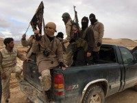 Al Qaeda-linked Nusra Front fighters carry their weapons on the back of a pick-up truck during the release of Lebanese soldiers and policemen in Arsal, eastern Bekaa Valley, Lebanon, December 1, 2015. REUTERS/STRINGER/FILES