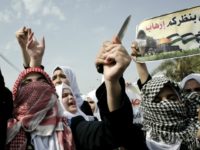 Palestinian students hold a knife during an anti-Israel protest in the city of Khan Yunis in the Southern Gaza Strip, on October 18, 2015.