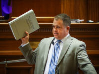 FILE - In this July 6, 2015, file photo, state Sen. Lee Bright, R-Spartanburg, holds the "Roll Call of the Dead" while making his case not to take down the Confederate flag during the South Carolina senate's debate on a bill that calls for the removal of the Confederate flag from the State House grounds in Columbia, S.C. Sen. Bright has proposed a bill to keep transgender people in restrooms that conform to their sex at birth. (Tim Dominick/The State via AP, File) ALL LOCAL MEDIA OUT, (TV, ONLINE, PRINT); MANDATORY CREDIT.