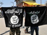 SRINAGAR, INDIA - JUNE 27: Kashmiri protesters displaying the flags of ISIS during a protest against alleged desecration of Jamia Masjid by police personnel yesterday after Friday prayers, on June 27, 2015 in Srinagar, India. Clashes broke out in several parts of downtown Srinagar on Saturday against the alleged desecration of Jamia Masjid by government forces yesterday. Reacting very sharply against police action, Auqaf Jamia Masjid, which functions under Mirwaiz, called for a shutdown in Srinagar followed by Geelani, Malik and Shah. (Photo by Waseem Andrabi/Hindustan Times via Getty Images)