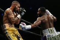 Ashley Theophane (L) and Adrien Broner exchange punches in their super lightweight championship bout, at the DC Armory in Washington, DC, on April 1, 2016