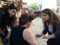 TURKEY, Bursa : A woman gives first aid to an injured woman following a bombing, in Bursa, northwestern Turkey, on April 27, 2016. A female suicide bomber blew herself up in Bursa on April 27, wounding at least 10 people in the latest attack to strike the country, local media reported. Security sources confirmed that the blast was a "suicide attack", while Turkish media identified the bomber as a 25-year-old woman. Nobody has yet claimed responsibility for the blast. / AFP PHOTO / ONUR YURTSEVER